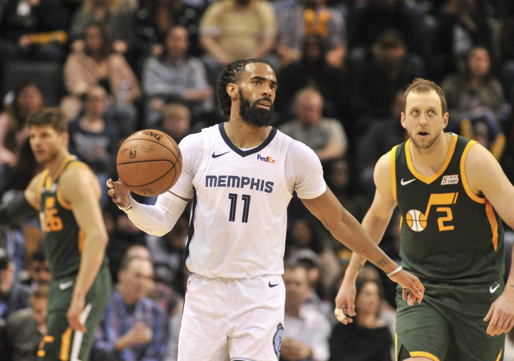 Mike Conley dribbling the basketball against his new team, the Utah Jazz